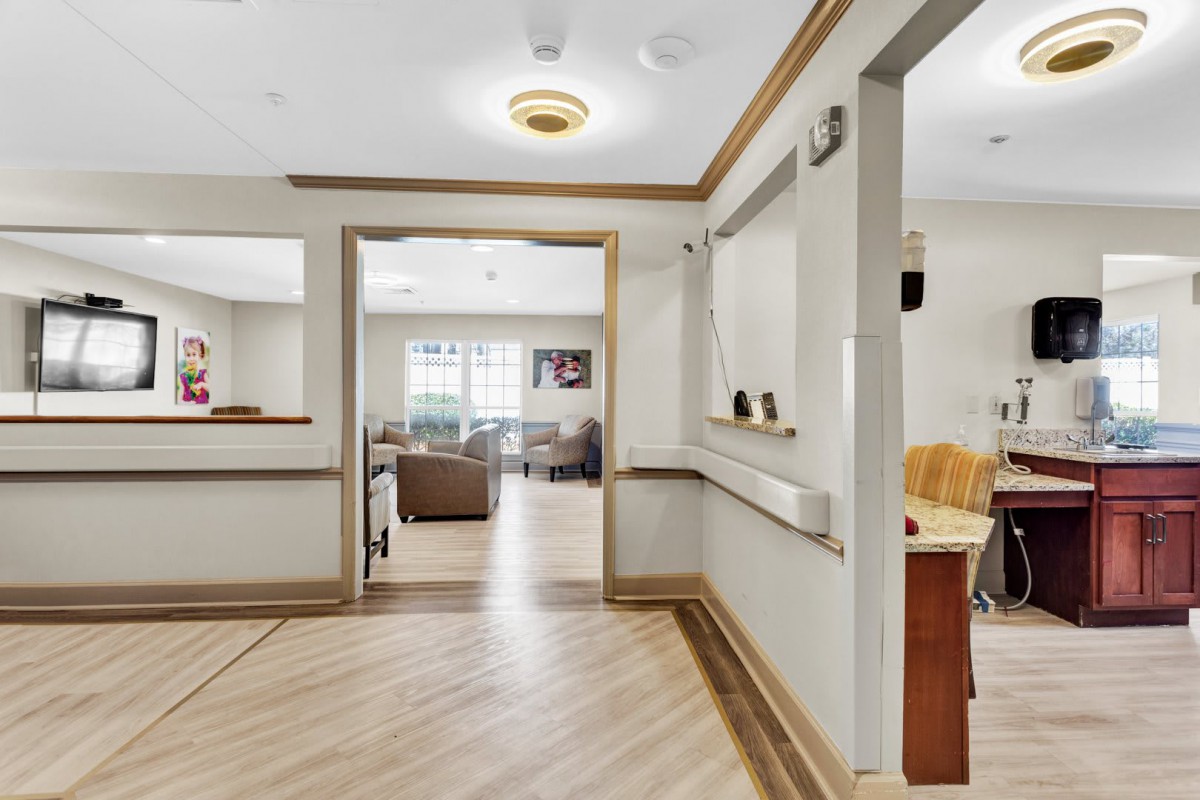 A spacious and well-lit interior hallway with seating areas and decor.