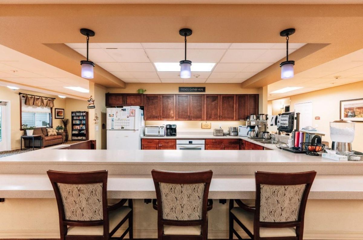 A cozy kitchen with a spacious countertop and bar seating.