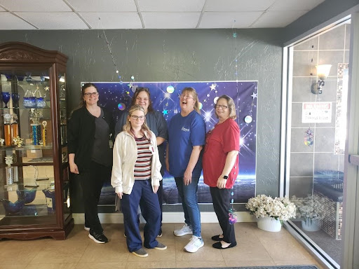 A cheerful group of friends posing together indoors.