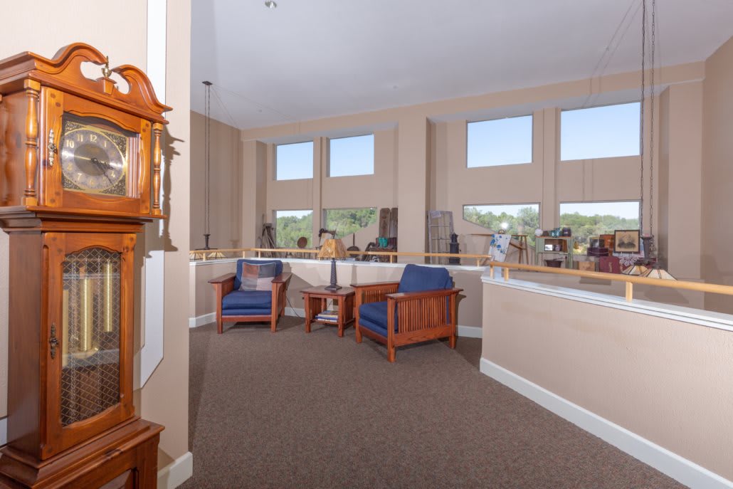 A spacious and well-lit lobby area with comfortable seating and large windows.