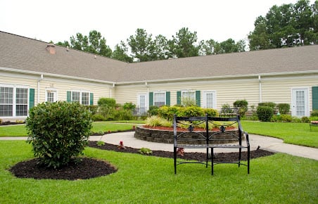 A well-maintained house with a landscaped garden and patio area.