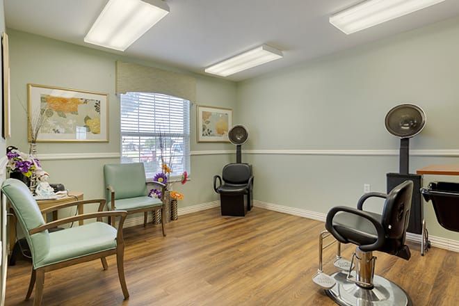 A cozy hair salon interior with a waiting area and styling stations.