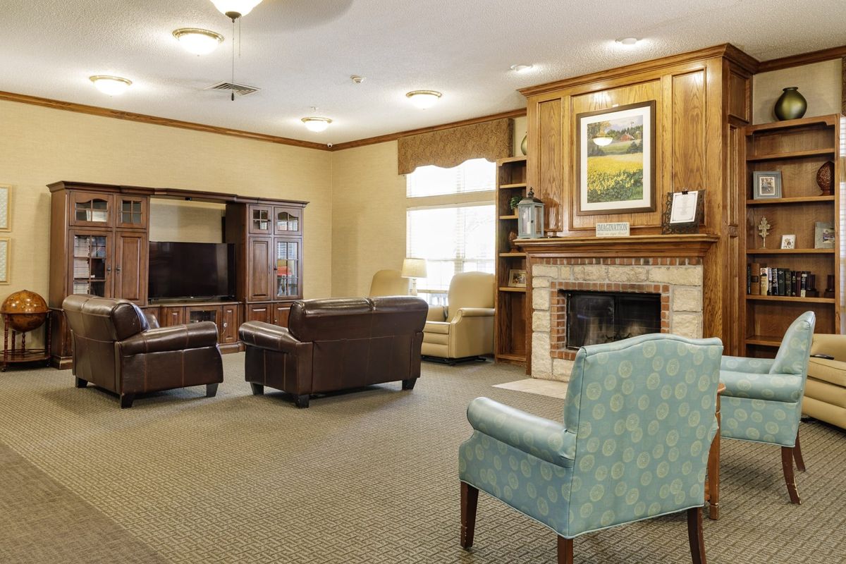 A cozy living room with comfortable seating and a fireplace.