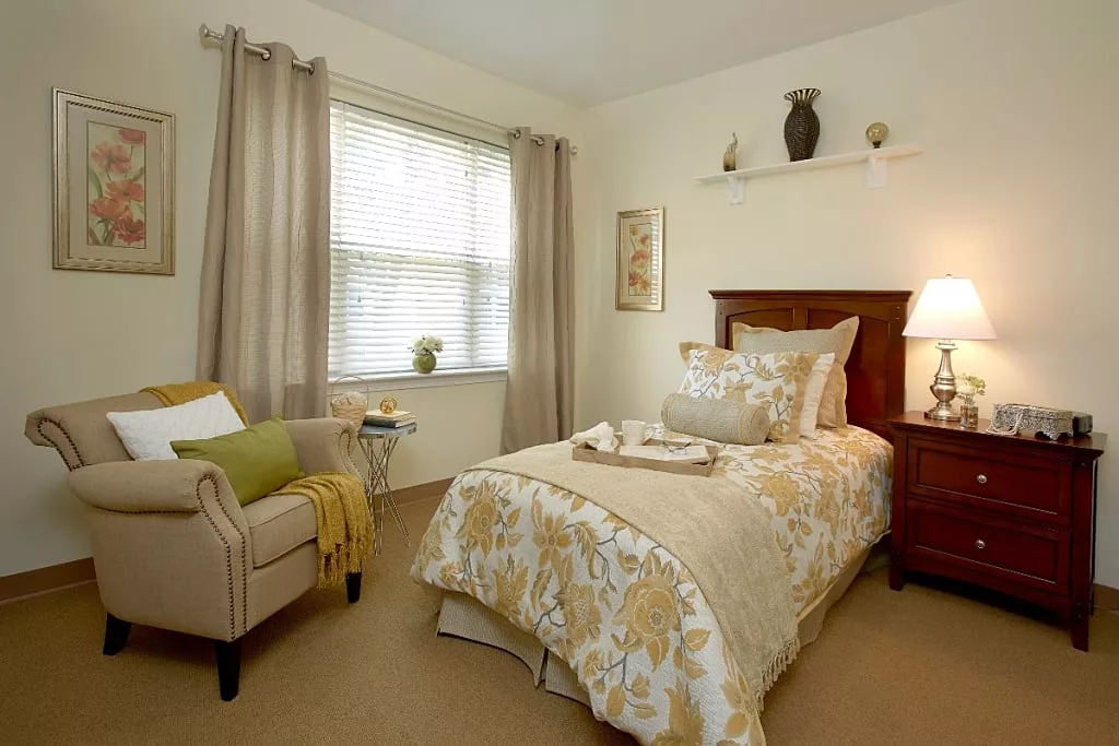 A cozy bedroom with a single bed, featuring neutral tones and elegant decor.