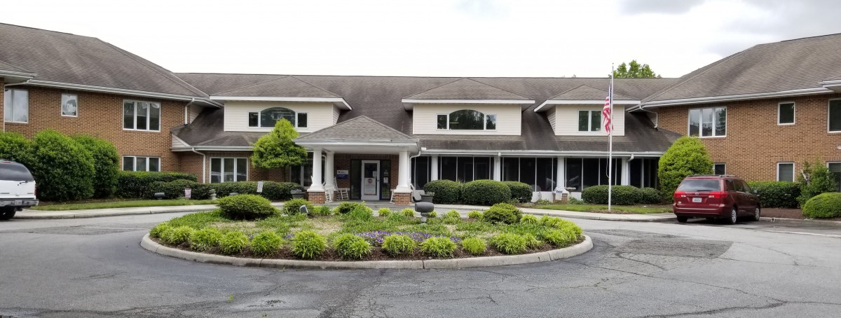 A two-story building with a landscaped front entrance.