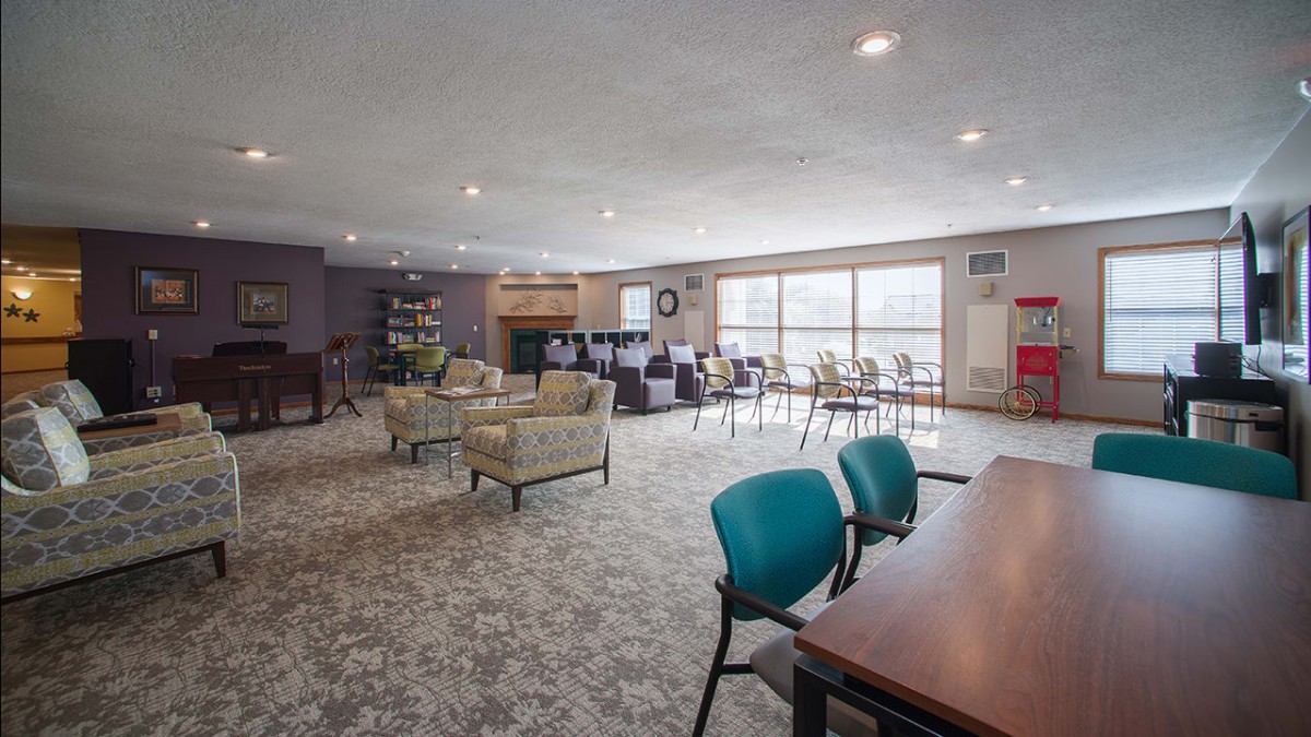 A spacious and modern lounge area with comfortable seating and large windows.