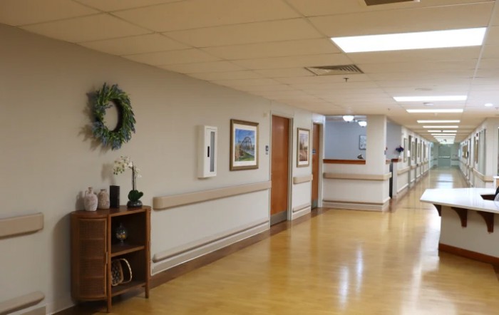 A quiet hospital hallway with artwork and decorations.