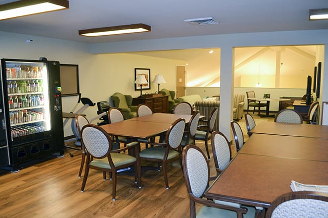 A cozy dining and lounge area with wooden flooring and comfortable seating.