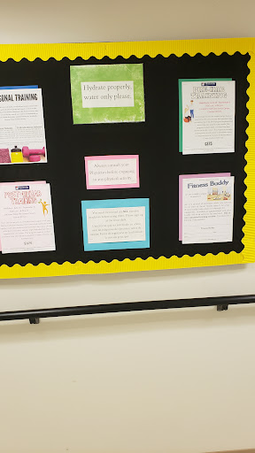 A bulletin board displaying various colorful educational materials in a classroom setting.