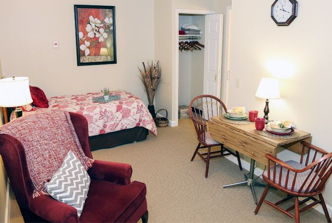 Cozy bedroom with a bed, desk, chair, and open closet.