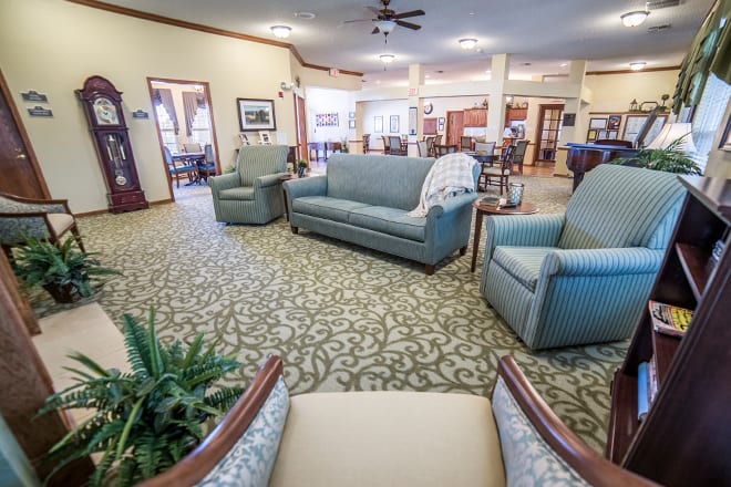 A spacious living room with comfortable seating and elegant dcor.