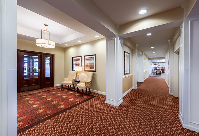 A well-decorated lobby area with chairs, artwork, and modern lighting.
