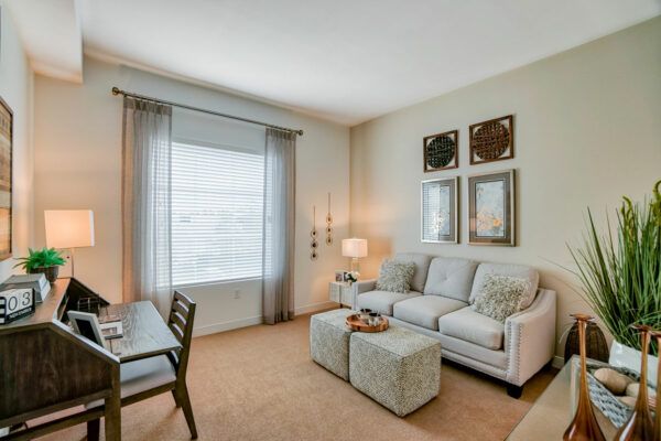 A cozy living room with a sofa, table, and wall artwork.