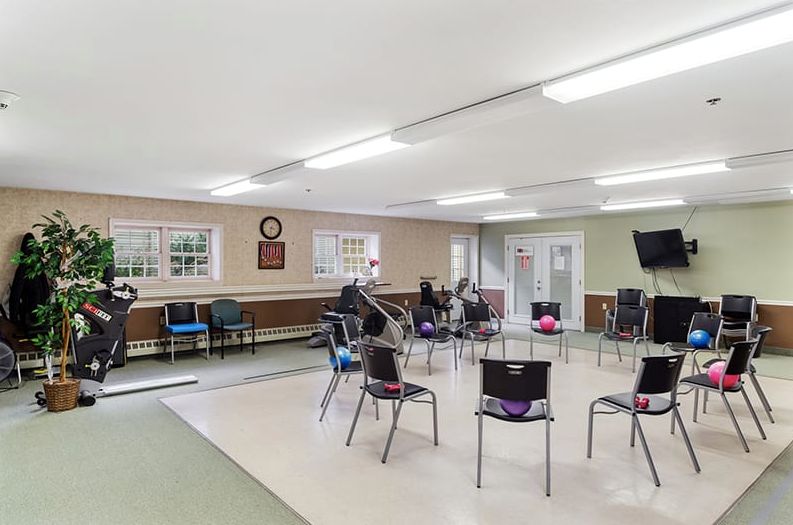 A spacious community room with chairs arranged in a circle, ideal for meetings or group activities.