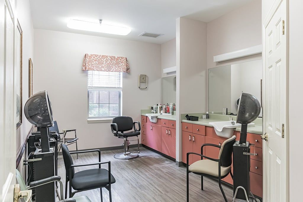 Interior of a hair salon with chairs and mirrors.
