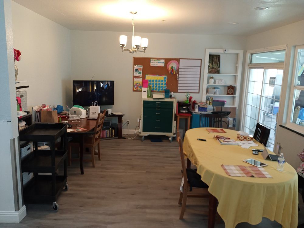 A home-based classroom setup with educational materials and organized workspaces.