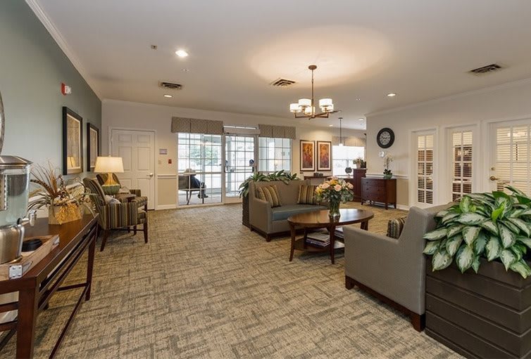 A spacious and well-lit living room with comfortable seating and elegant decor.