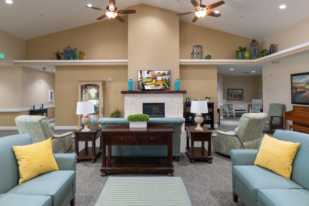 A well-decorated living room featuring a cozy arrangement with sofas and a fireplace.