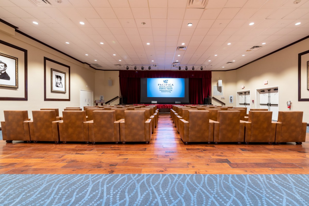 A cozy theater room with comfortable seating and a large screen for viewing.