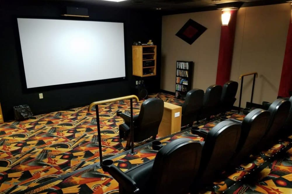 A cozy home theater setup with comfortable seating and a large screen.