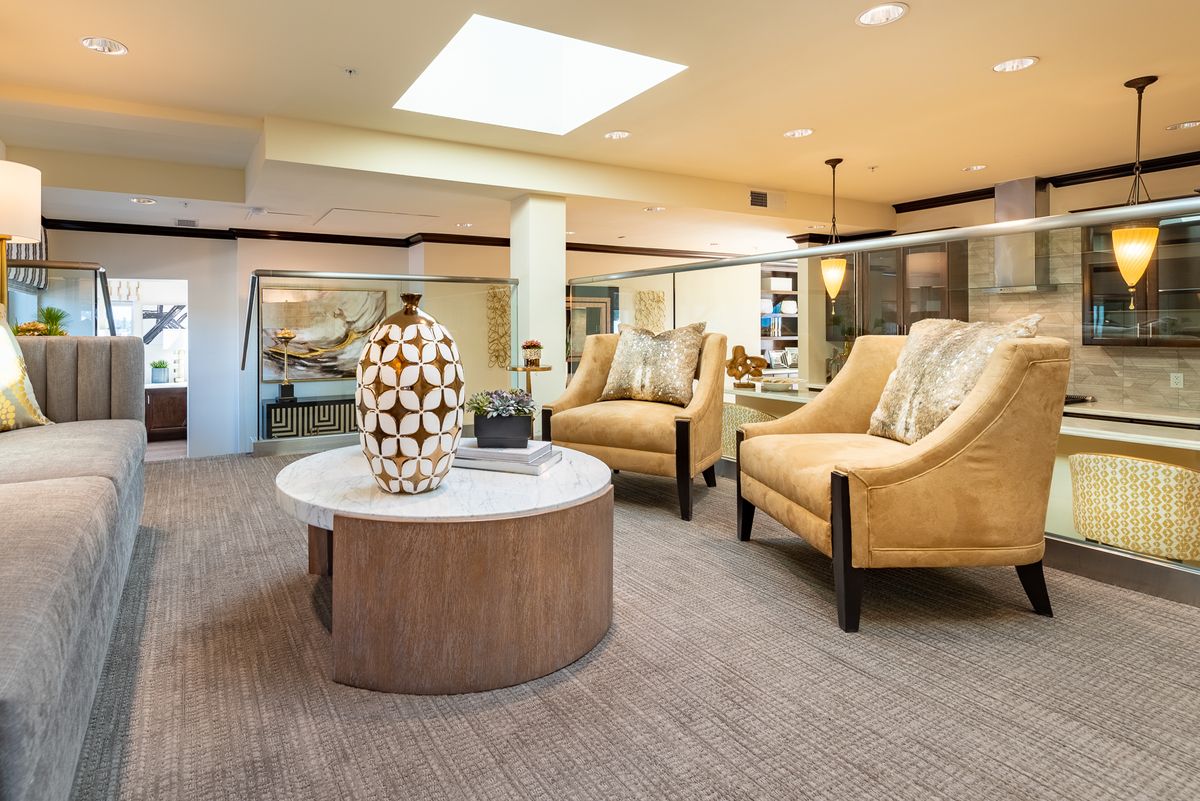 A cozy living room space featuring elegant armchairs and a stylish coffee table with decorative elements.