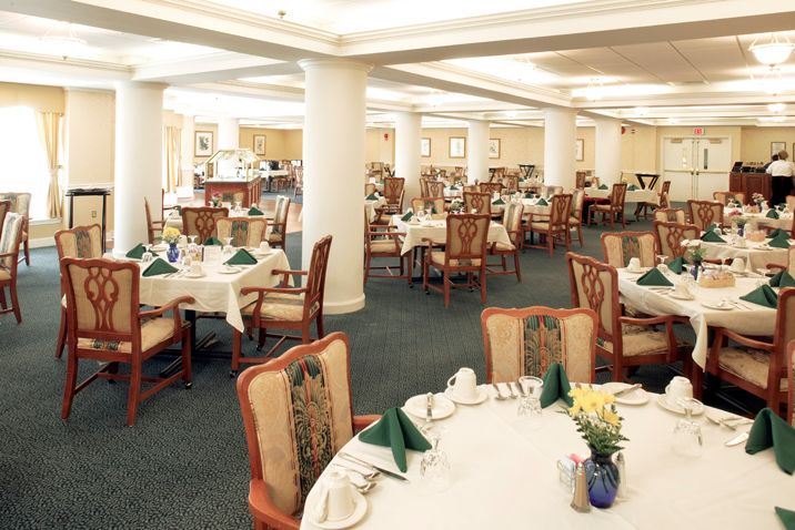 Elegant dining area set up with neatly arranged tables and chairs.