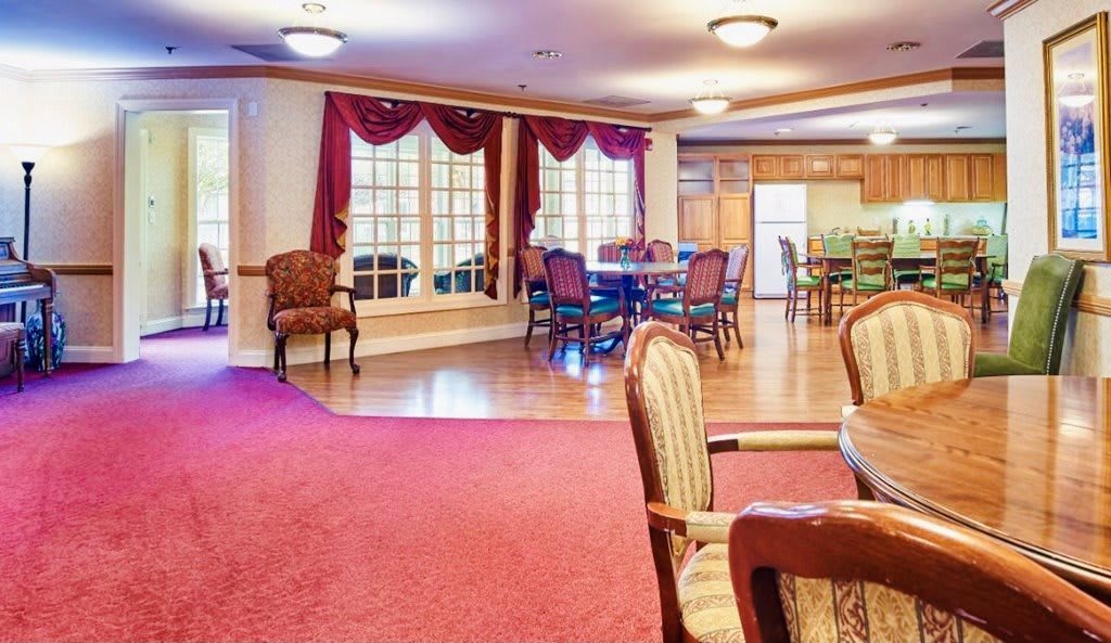 A spacious dining area with elegant furniture and large windows.