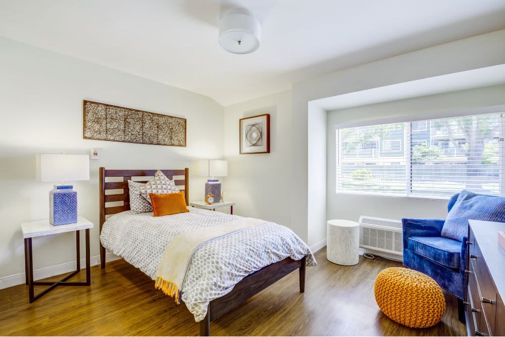 A cozy bedroom with bright decor and modern furnishings.