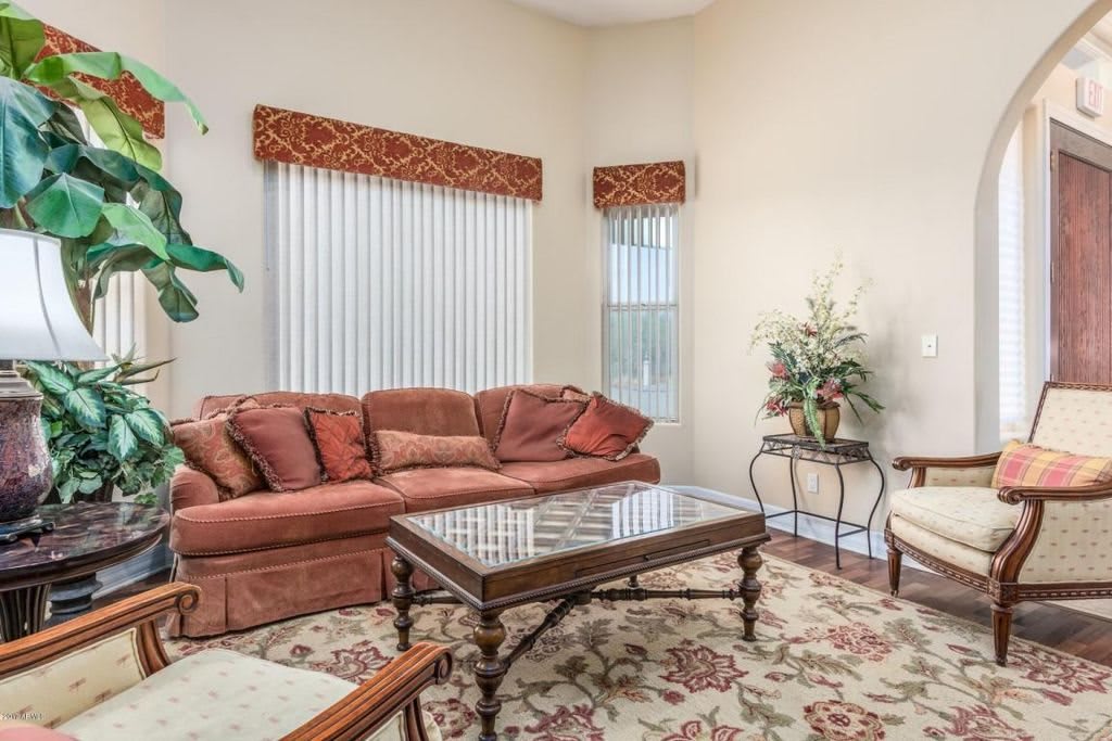 A cozy living room with a plush sofa and decorative elements.