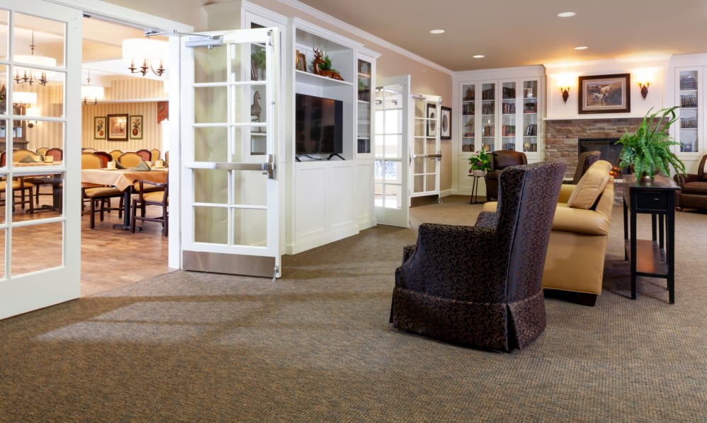 A cozy living room with comfortable seating, a television, and built-in bookshelves.