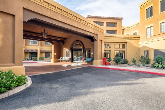 The entrance of a stylish hotel with a welcoming archway and modern design.