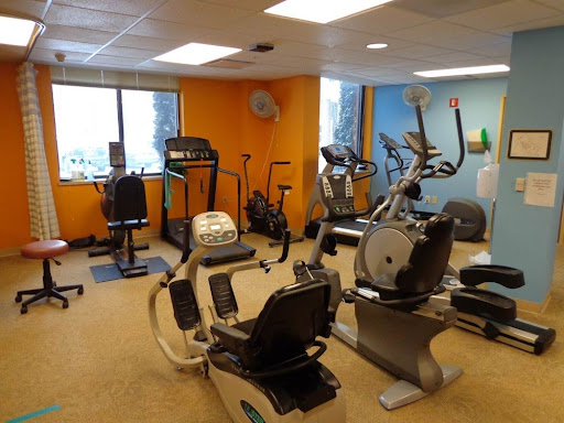 A well-equipped fitness room featuring various exercise machines for a complete workout experience.