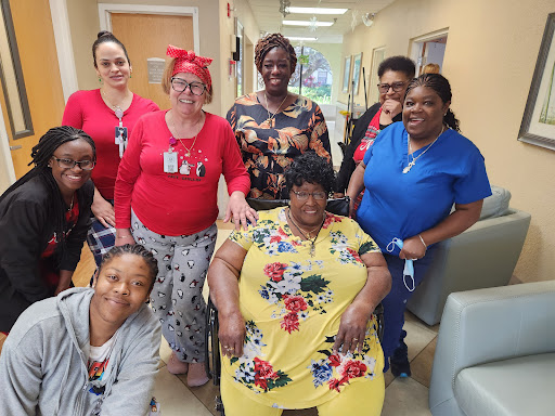 A joyful gathering of staff and residents at a care facility, celebrating together.