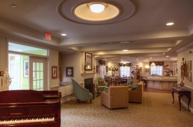 A cozy lounge area with comfortable seating and a piano.