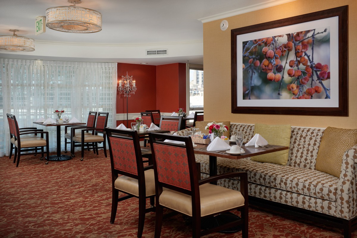 A cozy dining room with elegant furnishings and artwork on the wall.