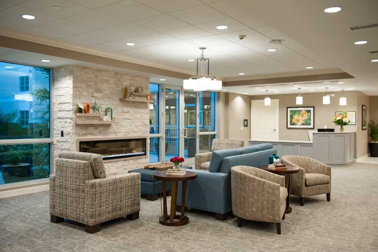 A modern lobby with comfortable seating and a cozy fireplace.