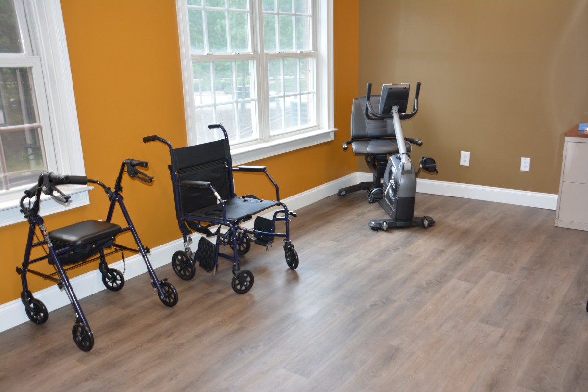 A room featuring mobility aids and exercise equipment by the window.