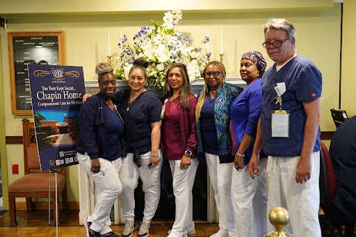 Healthcare team gathers for a group photo at an event.