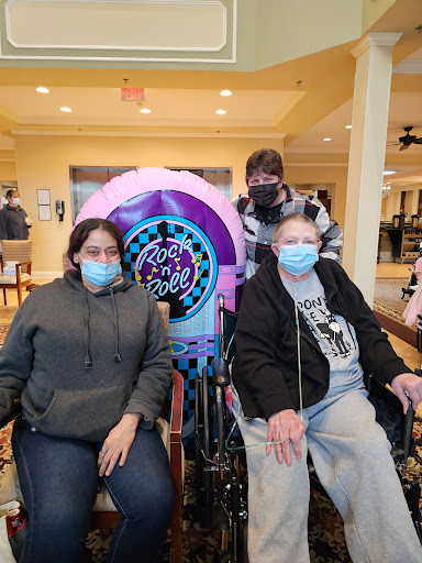 A heartfelt moment shared among family members at an assisted living facility.