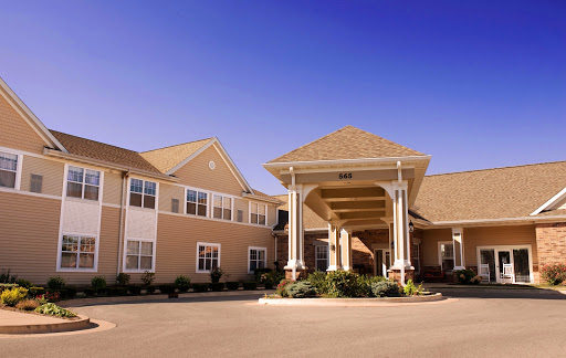 A welcoming entrance to a residential building under a clear blue sky.