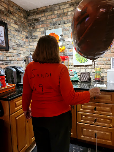 Celebrating a special occasion in a cozy kitchen setting.