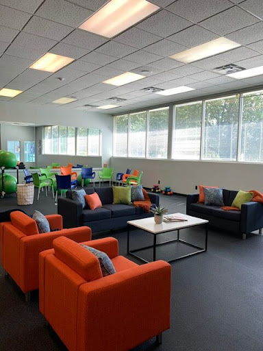 A vibrant lounge space featuring comfortable seating and large windows, perfect for relaxation or informal meetings.