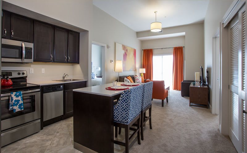 A modern apartment with an open-plan kitchen and living area.
