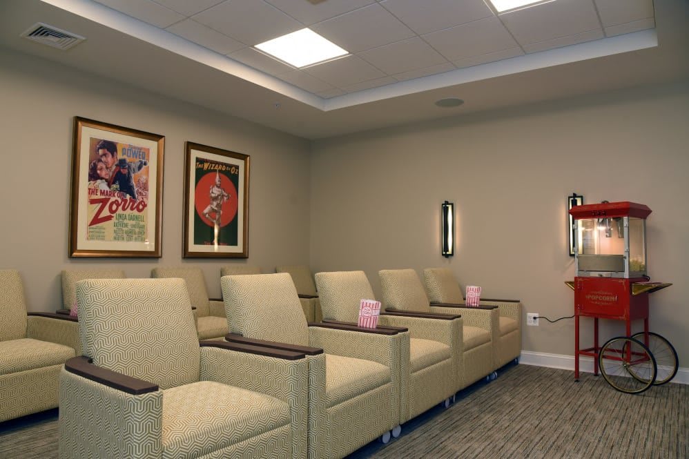 A well-arranged waiting room with comfortable chairs and framed artwork on the wall.
