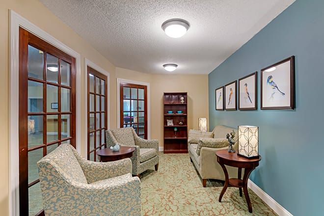 A cozy living room with comfortable seating and decorative elements.