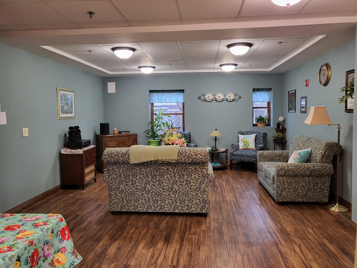 A cozy living room with sofas, chairs, and decorative elements.