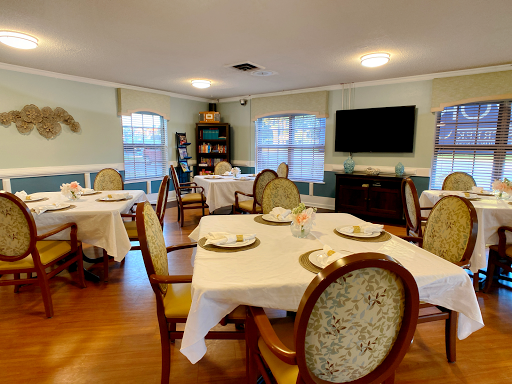 A cozy dining area set up with tables and chairs, ready for a meal.