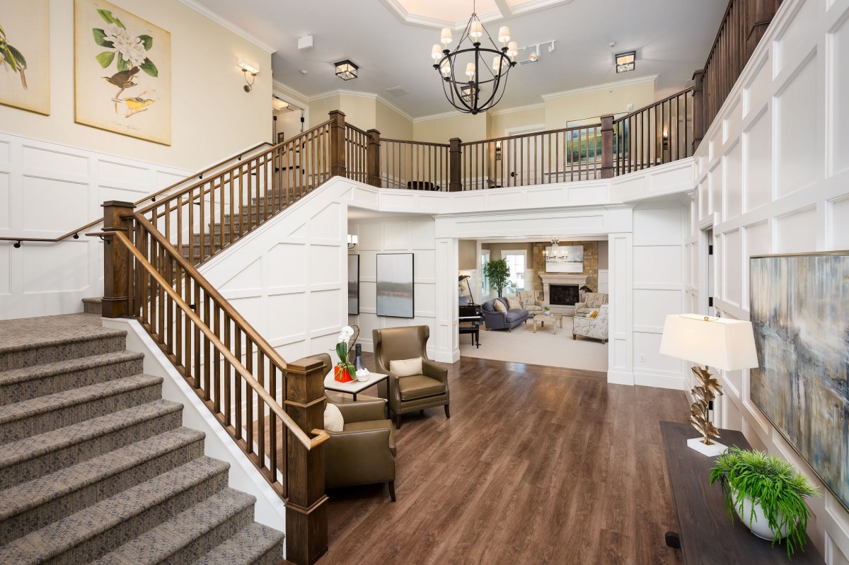 Spacious living area with a grand staircase and elegant decor.