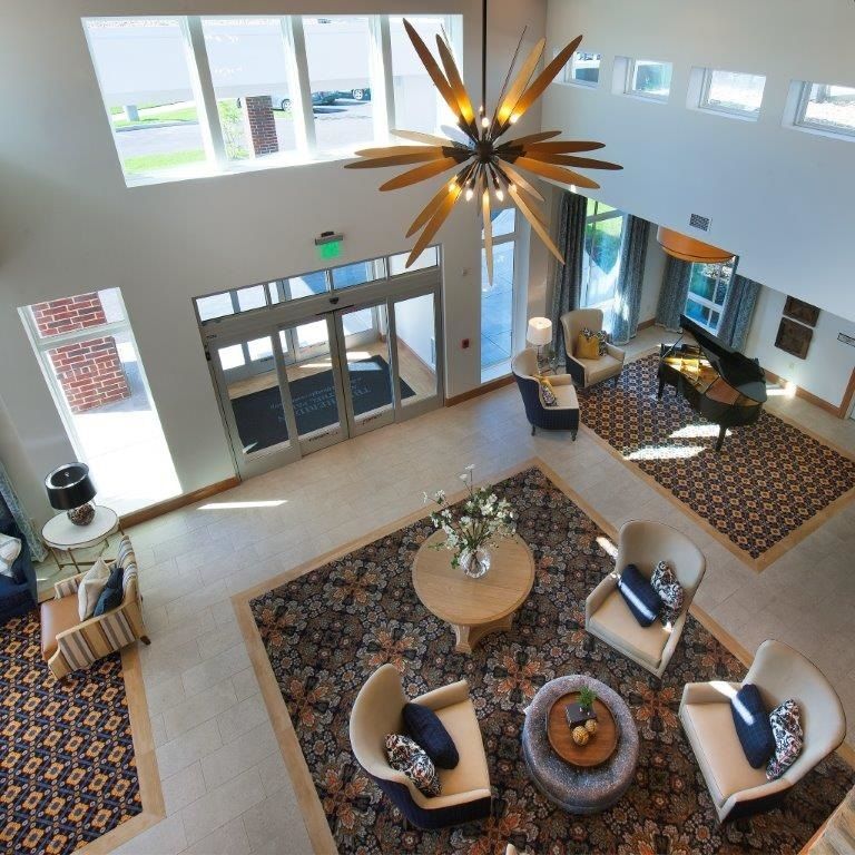 A modern lobby featuring stylish furniture and a striking chandelier.