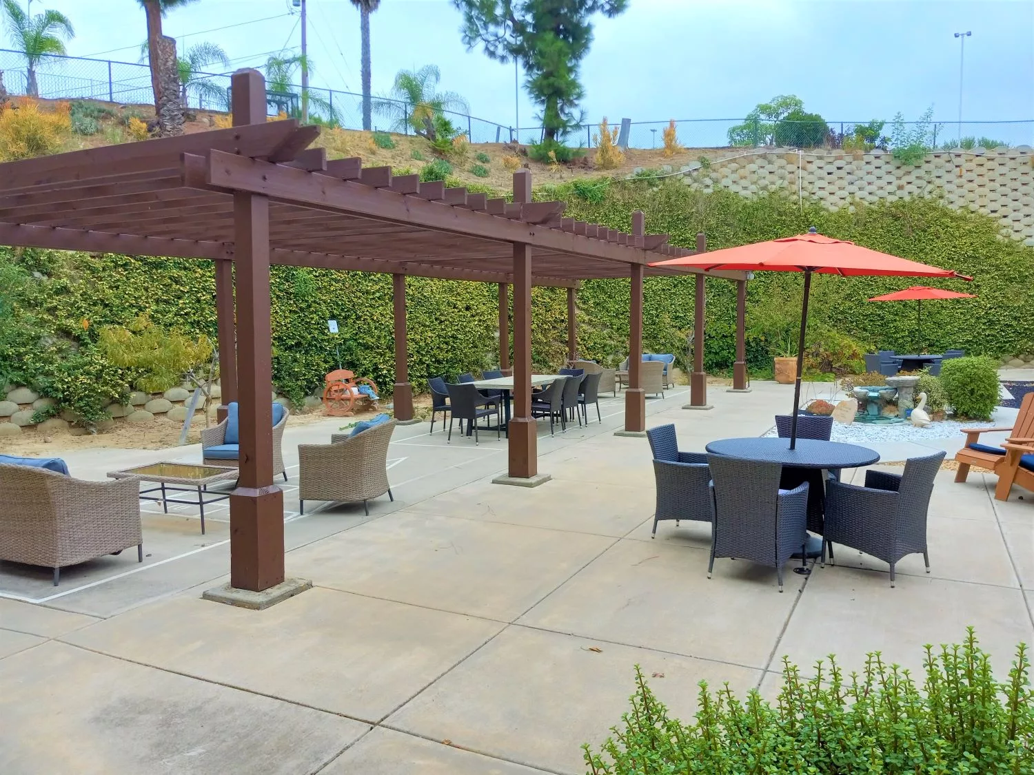 Outdoor patio area with pergolas and furniture.